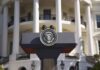Presidential podium with seal in front of white-columned building
