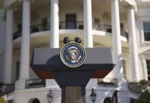 Presidential podium with seal in front of white-columned building