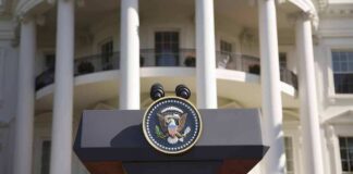 Presidential podium with seal in front of white-columned building