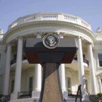 Behind The Toasts, A Much Bigger Game Press podium with presidential seal in front of the White House