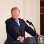 Trump Wants In. Some Republicans Face A Calculation man at podium with presidential seal