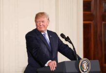 man at podium with presidential seal