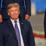 A Presidential Visit Met A Wild Golf Finish smiling man in a navy suit at an outdoor event