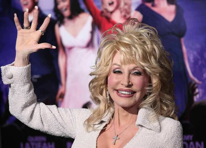 blonde woman waving at a red carpet event