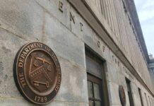 U.S. Treasury building exterior with bronze seal on stone wall