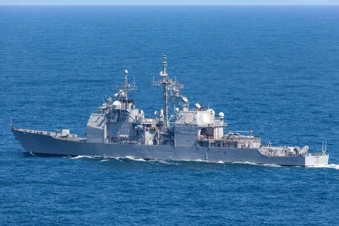 Gray naval warship cruising on open sea