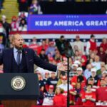 Texas Showdown: MAGA Money Erupts Crowd at a political rally with a speaker at a podium; Stephen Paea, Curtis Lofton, Walter Jones, John Sullivan, and Colin David Jones present