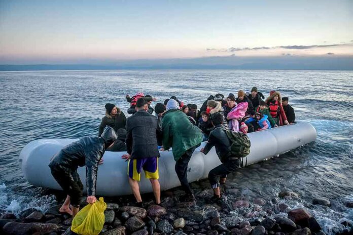 People arriving in a crowded inflatable boat at a rocky shore