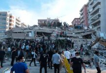 Rescue workers and civilians on collapsed building after earthquake