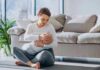 Mother breastfeeding baby on living room floor