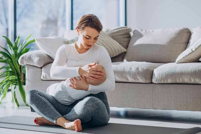 Mother breastfeeding baby on living room floor