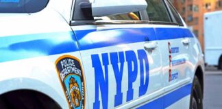 NYPD police car side with blue stripes and emblem