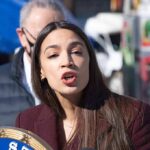 Missing Records Cloud AOC Jan. 6 Tale Woman speaking at an outdoor press event