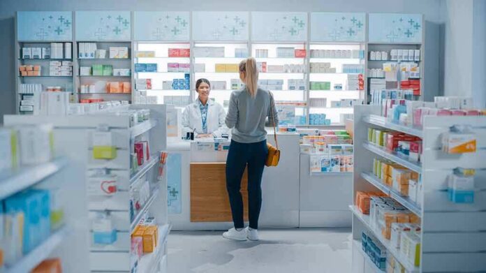 shutterstock_1952231947 Yvonne Li assisting a customer at a pharmacy counter