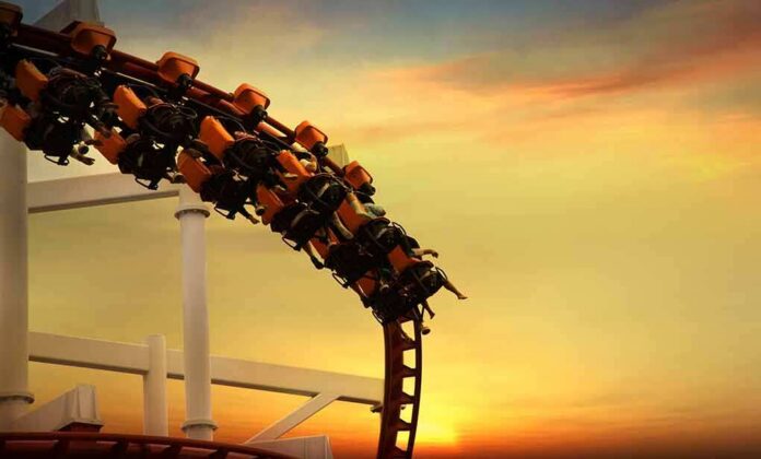 shutterstock_195316547 roller coaster train rounding a curve at sunset