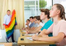 Pride Flag Fight Ends With Major Court Ruling Students in a classroom listening as a teacher holds a rainbow flag