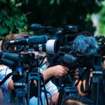 Paris Uproar: Women Sidelined, Gates Close TV news cameras crowding together at an outdoor event