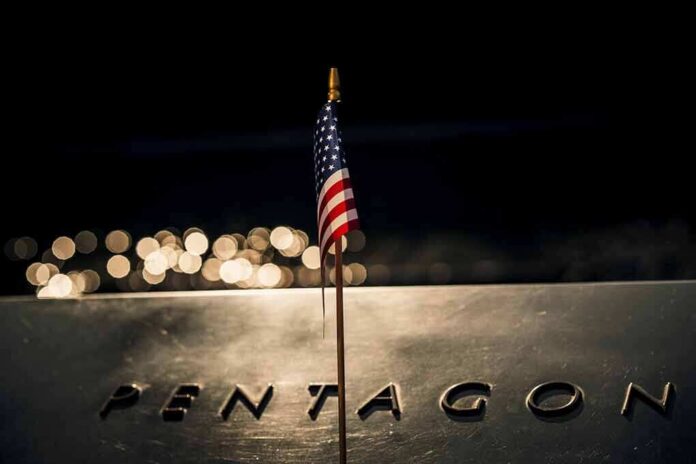 Small American flag on a memorial with bokeh lights at night
