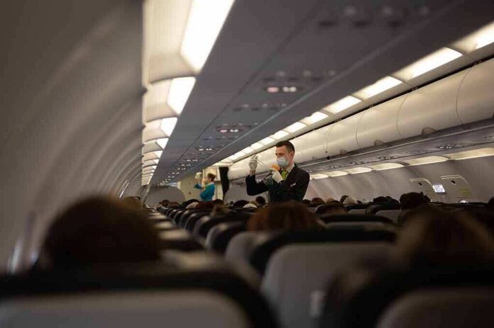 Flight attendant demonstrates safety procedures in airplane cabin