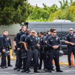 Police Pull Alarm On LA Power Shift Group of police officers standing in a parking lot