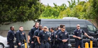 Group of police officers standing in a parking lot