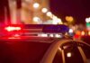 A Zero Breath Test Ended With Handcuffs Police car with flashing red and blue lights at night
