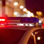 A Zero Breath Test Ended With Handcuffs Police car with flashing red and blue lights at night