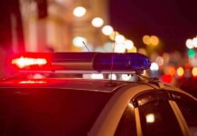 Police car with flashing red and blue lights at night