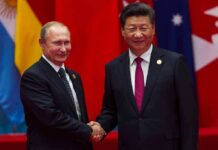 two men in suits shaking hands