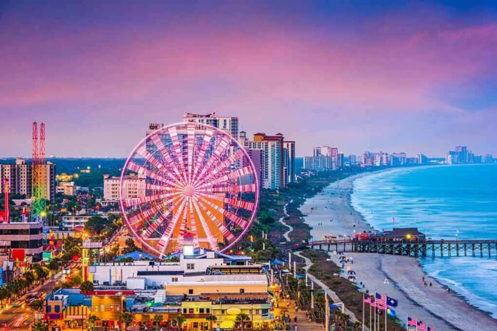 Ferris wheel on a beachfront city at sunset
