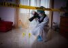 forensic photographer documenting indoor crime scene