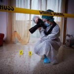 forensic photographer documenting indoor crime scene