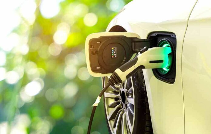 Electric car charging port with plugged-in cable