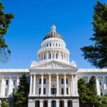20,000 Flagged – California Pushes Back State capitol building with white dome and columns framed by trees