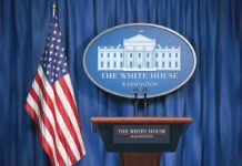 A New Face Prepares for the White House Podium White House press briefing podium and US flag