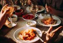 Pasta dinner with wine on a sunlit table