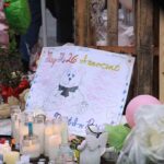Vigil Flames, Unsettling Questions Linger A memorial site with candles, flowers, and a hand-drawn poster