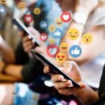 people using smartphones with social media reactions