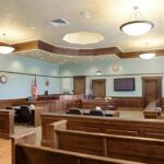 Staged Suicide? Jury Sees Disturbing Clues Empty courtroom with wooden benches and judge's bench