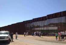 Border Flip: Deportation Reunites Families Border fence with group of people and a patrol vehicle
