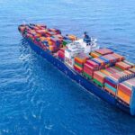 Container ship carrying colorful cargo containers at sea