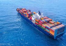 Container ship carrying colorful cargo containers at sea