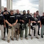 Behind Closed Doors, a Federal Probe Escalates Group of law enforcement officers with tactical gear and a K9