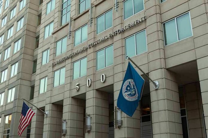 U.S. government building facade with American and blue departmental flags