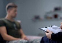 A Surprising Breakthrough Offers Hope for Veterans Therapist taking notes while man sits on couch