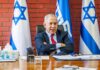 Power Play: Trump Bets On Netanyahu man in suit seated at a desk with Israeli flags behind him