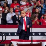 Brazil’s Surprise Result Just Got Trump’s Attention Donald Trump points from a rally stage; Rudi Koertzen and Bear Pascoe are in the crowd