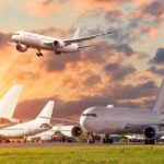 A Major Airport Becomes the Latest Missile Target Passenger jets on airport tarmac with one aircraft landing at sunset