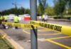 Police tape cordons off a street scene