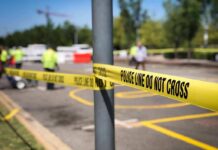 Police tape cordons off a street scene